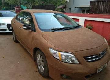 Ahmedabad woman covers her car with cow dung to keep it cool