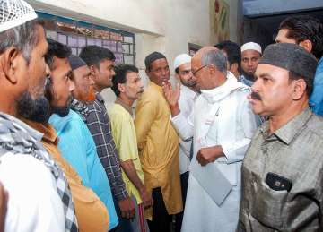 Congress candidate for Bhopal seat Digvijay Singh interacts with voters at a polling booth during the sixth phase of Lok Sabha polls, in Bhopal