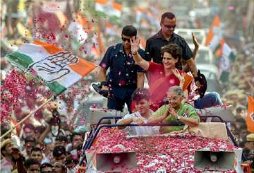 Congress General Secretary Priyanka Gandhi Vadra with Sheila Dikshit wave at supporters during an election roadshow for the Lok Sabha polls