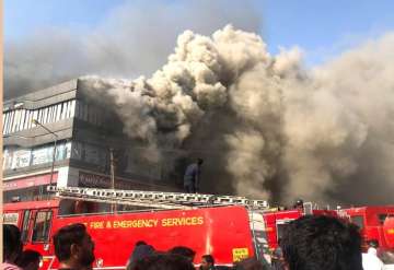 Smoke coming out from the Taxshila Complex after a fire engulfed the third and fourth floor of the coaching centre, in Surat.