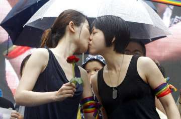 Same-sex marriage supporters kiss outside the Legislative Yuan Friday, May 17, 2019, in Taipei