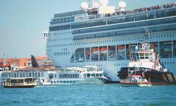 Video on social media showed the huge cruise ship heading for the dock, shoving the smaller boat out of the way, and causing onlookers on land to flee.