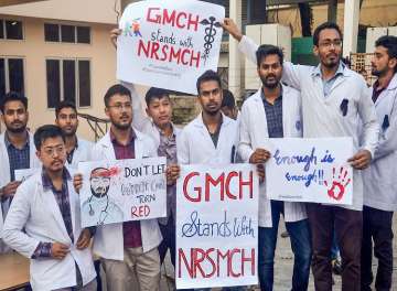 Medical student hold placards showing solidarity with the intern doctor who was assaulted in West Bengal, at Gauhati Medical College
 