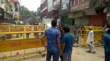 People stand near the temple on Tuesday.