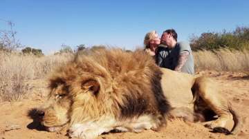 Couple hunt lion, kiss next to corpse in South Africa, Netizens get angry