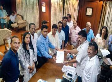 Ten of 15 Congress members led by leader of opposition Chandrakant Kavlekar gives letter for merger of their faction in BJP to Speaker Rajesh Patnekar, in Panaji