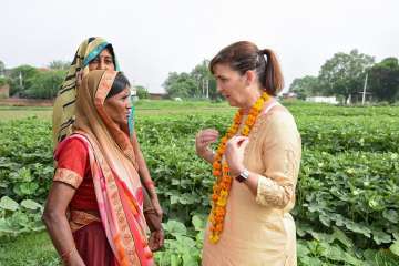 Walmart International President & CEO Judith McKenna interacts with farmers during her visit to Agra