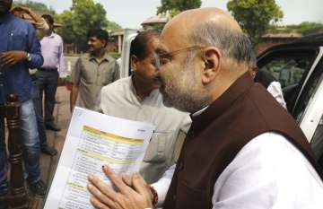 Amit Shah arrives at the Parliament carrying copy of a confidential document that lists out the procedure for revoking Kashmir's special status in New Delhi, India, Monday, Aug.5, 2019.?