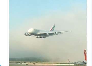 Emirates A380 makes 'majestic' landing through white foamy clouds at London airport. Watch video