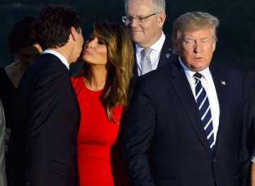 Canada's Prime Minister Justin Trudeau greets Melania Trump as she arrives for a family photo with President Donald Trump, during the G7 Summit in Biarritz, France, Sunday, Aug. 25, 2019. (Sean Kilpatrick/Pool via AP)