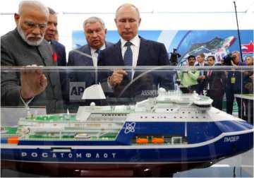 Russian President Vladimir Putin, right, and Indian Prime Minister Narendra Modi, left, look at a model of a Leader nuclear-powered icebreaker as they visit the Zvezda shipyard in the town of Bolshoi Kamen, Russia