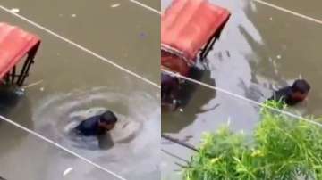 Bihar Floods 2019: Rickshaw puller cries while pulling his vehicle through a flooded street