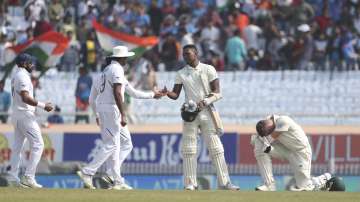 South Africa's Anrich Nortje, right, reacts as his teammate Lungi Ngidi, second right, shakes hands with Indian players after their loss on the fourth day of third and last cricket test match between India and South Africa in Ranchi