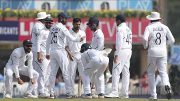 India's Sahbaz Nadeem, center without cap, and teammates celebrate the dismissal of South Africa's Theunis de Bruyn during the fourth day of third and last cricket test match between India and South Africa in Ranchi