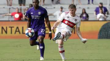 Chicago Fire's Bastian Schweinsteiger, right, passes the ball in front of Orlando City's Kamal Mille