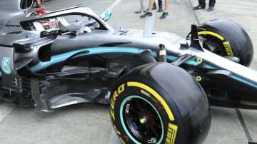 Mercedes driver Lewis Hamilton of Britain steers his car out of the garage during the first practice session for the Japanese Formula One Grand Prix at Suzuka Circuit in Suzuka