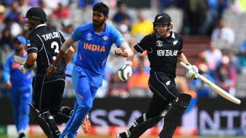 Tom Latham and Ross Taylor of New Zealand run as Jasprit Bumrah of India looks on during resumption of the Semi-Final match of the ICC Cricket World Cup 2019 between India and New Zealand after weather affected play at Old Trafford on July 2