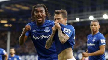 Everton's Bernard, centre, celebrates scoring his side's first goal of the game against West Ham, with teammate Alex Iwobi, left, during their English Premier League soccer match at Goodison Park in Liverpool