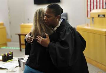 Judge hugs convicted ex-police officer after sentencing, gives her Bible. Watch Video