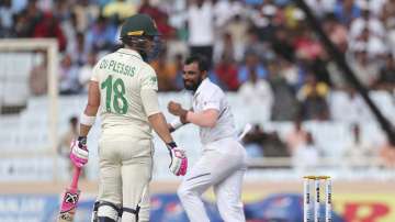 South Africa's captain Faf du Plessis, left, looks back after being dismissed by India's Mohammed Shami, right, during the third day of third and last cricket test match between India and South Africa in Ranchi