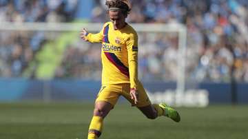 Barcelona's Antoine Griezmann runs with the ball during the Spanish La Liga soccer match between Getafe CF and FC Barcelona in Getafe, outskirts of Madrid (AP)