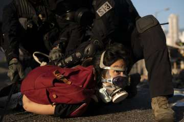 Police detain an anti-government protester in Hong Kong.