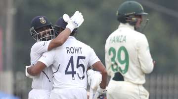 India's Ajinkya Rahane, left, hugs teammate Rohit Sharma to congratulate on scoring a century during first day of the third and last cricket test match between India and South Africa in Ranchi, India, Saturday