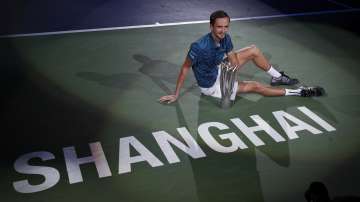 Daniil Medvedev of Russia poses with his winner's trophy on the court after defeating Alexander Zverev of Germany in the men's final at the Shanghai Masters tennis tournament at Qizhong Forest Sports City Tennis Center in Shanghai