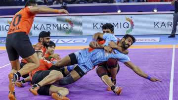 Players of U Mumba (Orange) and Bengal Warriors (Blue) in action during Semifinals 2 of Pro Kabaddi League, in Ahmedabad, Wednesday