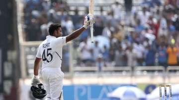 India's Rohit Sharma raises his bat to acknowledge the applause from the spectators after scoring double century during the second day of third and last cricket test match between India and South Africa in Ranchi