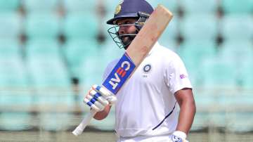 India's Rohit Sharma raises his bat after scoring fifty runs during the first day of the first cricket test match against South Africa in Visakhapatnam (AP)