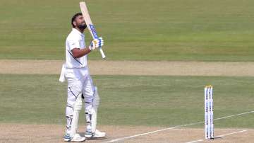 India's Rohit Sharma raises his bat after scoring hundred runs during the first day of the first cricket test match against South Africa in Visakhapatnam (AP)