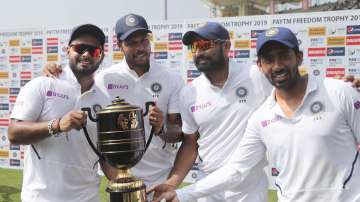 From left, India's Rishabh Pant, Umesh Yadav, Mohammed Shami and Wriddhiman Saha pose with the winners trophy after their win on the fourth day of third and last cricket test match between India and South Africa