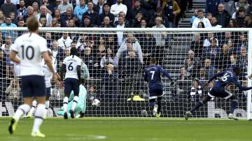 Watford's Abdoulaye Doucoure, 16 at 2nd right, celebrates scoring his side's first goal of the game against Tottenham during their English Premier League soccer match at Tottenham Hotspur Stadium in London