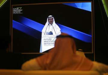 Participants watch Saudi Energy Minister Prince Abdulaziz bin Salman on a screen during his speech at the Future Investment Initiative forum in Riyadh