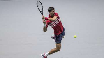 Serbia's Novak Djokovic returns the ball to Russia's Karen Khachanov during their Davis Cup tennis match in Madrid