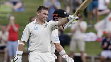 New Zealand's Tom Latham celebrates after scoring a century during play on day one of the second cricket test between England and New Zealand