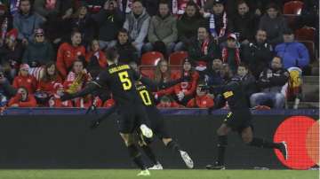 Inter Milan's Romelu Lukaku, right, celebrates with teammates after scoring his side's second goal during the Champions League group F soccer match between Slavia Praha and Inter Milan at the Sinobo stadium in Prague