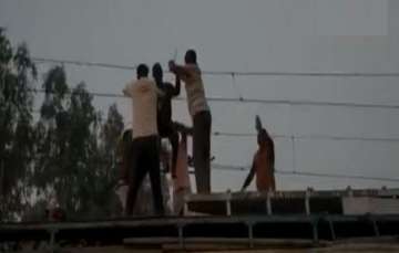 Latest News Man Dangling From Overhead Wire Train Tracks Rescued Madhya Pradesh, Video shows dramati