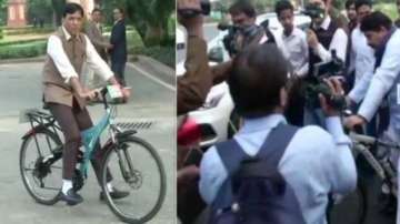 MPs ride bicycle to arrive at parliament for winter session