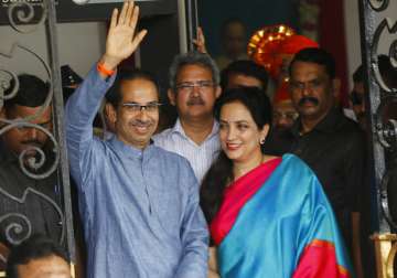 Shiv Sena chief Uddhav Thackeray waves to the crowd, with his wife Rashmi by his side, outside the Brihanmumbai Municipal Corporation (BMC) office building in Mumbai, India, Friday, Nov. 22, 2019.   Uddhav will lead the next Maharashtra govt.