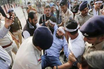 An injured protestor being carried away at a demonstration in Ahmedabad on Thursday