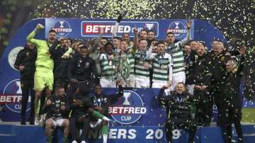 Celtic celebrate with the trophy after the Scottish Cup soccer Final between Celtic and Rangers at Hampden Park, Glasgow, Scotland, Sunday