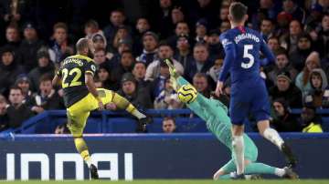 Southampton's Nathan Redmond, left, scores his side's second goal of the game during their English Premier League soccer match against Chelsea at Stamford Bridge