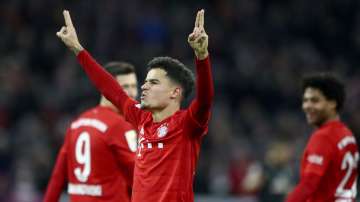 Bayern's scorer Philippe Coutinho, front, celebrates after scoring his side's sixth goal during the German Bundesliga soccer match between FC Bayern Munich and SV Werder