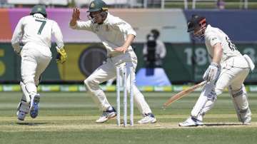 Australia's Tim Paine, left, celebrates with teammate Marnus Labuschagne, center, after stumping out New Zealand's Henry Nicholls, right, during play in their cricket test match in Melbourne