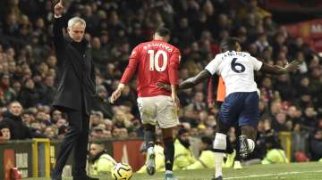 Tottenham's manager Jose Mourinho, left, reacts as Manchester United's Marcus Rashford, centre, and Tottenham's Davinson Sanchez challenge for the ball during the English Premier League soccer match between Manchester United and Tottenham Hotspur