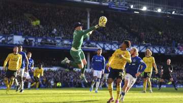 Everton goalkeeper Jordan Pickford, center, collects the ball during the English Premier League soccer match between Everton and Arsenal at Goodison Park