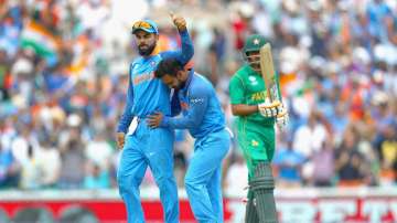 Kedar Jadhav of India celebrates the wicket of Babar Azam of Pakistan with Virat Kohli during the ICC Champions trophy cricket match between India and Pakistan at The Oval in London on June 18, 2017