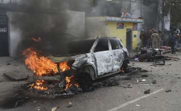 Vehicle set ablaze in violent protest in Lucknow.